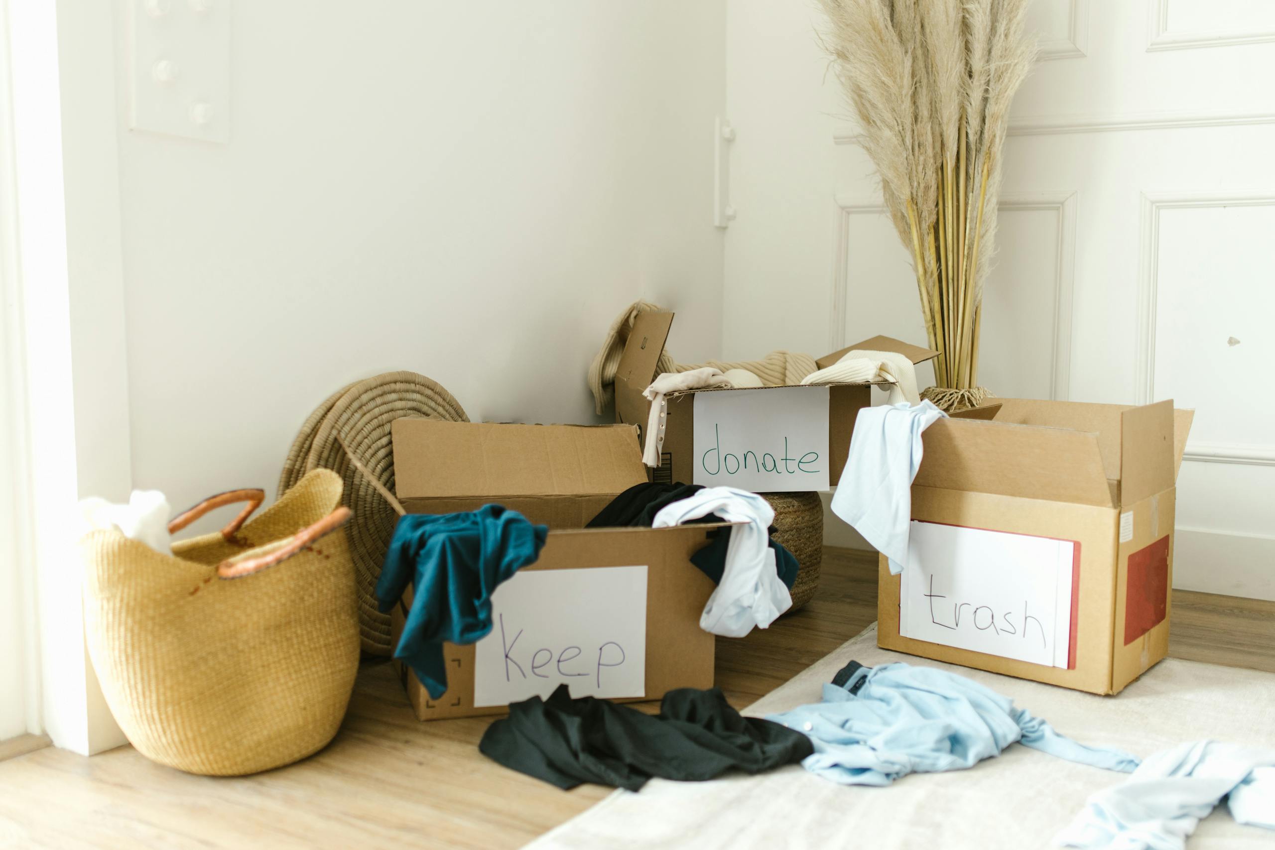 Cardboard boxes labeled 'Keep', 'Donate', and 'Trash' for guide on decluttering and how to declutter your home.