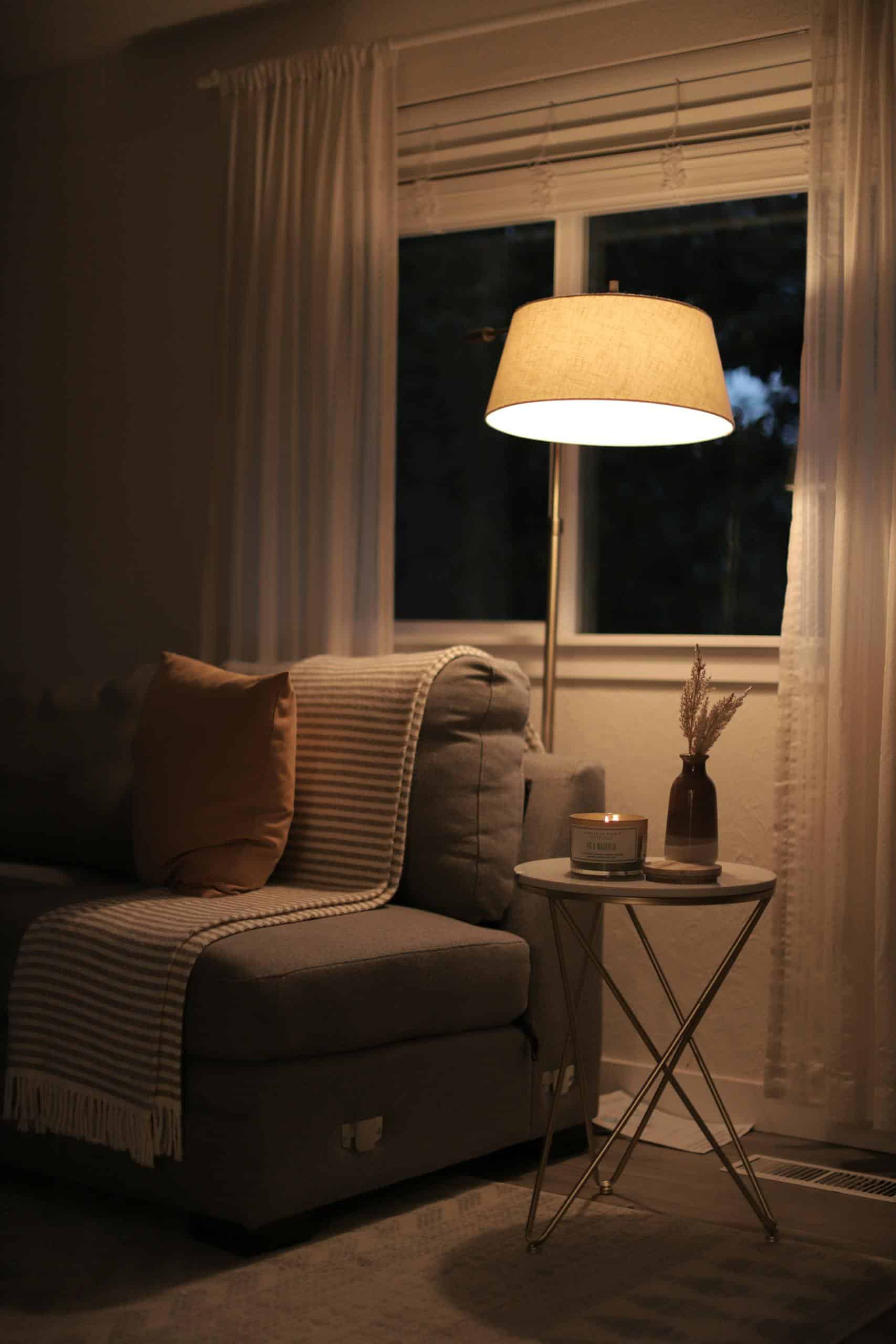 A warm, inviting living room with soft lighting, a comfy sofa, and stylish decor.