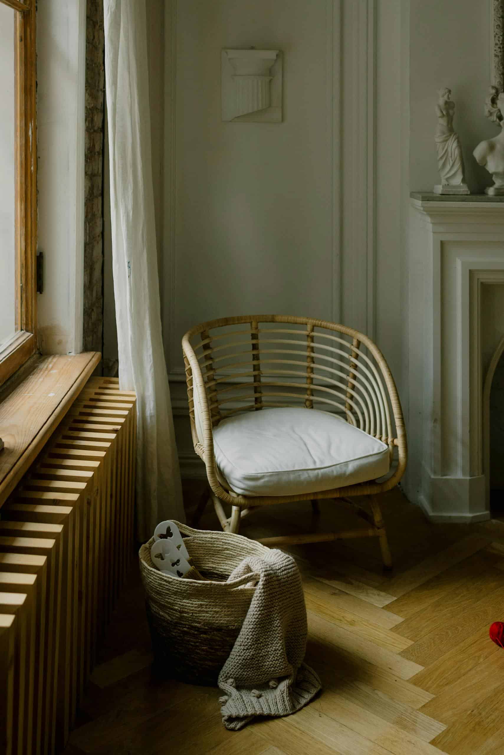 Serene interior design scene with a wicker chair and soft lighting in a Scandinavian style corner.