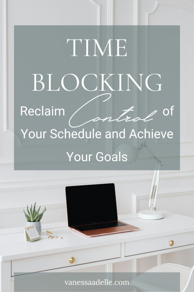An image of a laptop on a white minimalist clutter-free desk with the text overlay Time Blocking Reclaim Control of Your Schedule and Achieve Your Goals