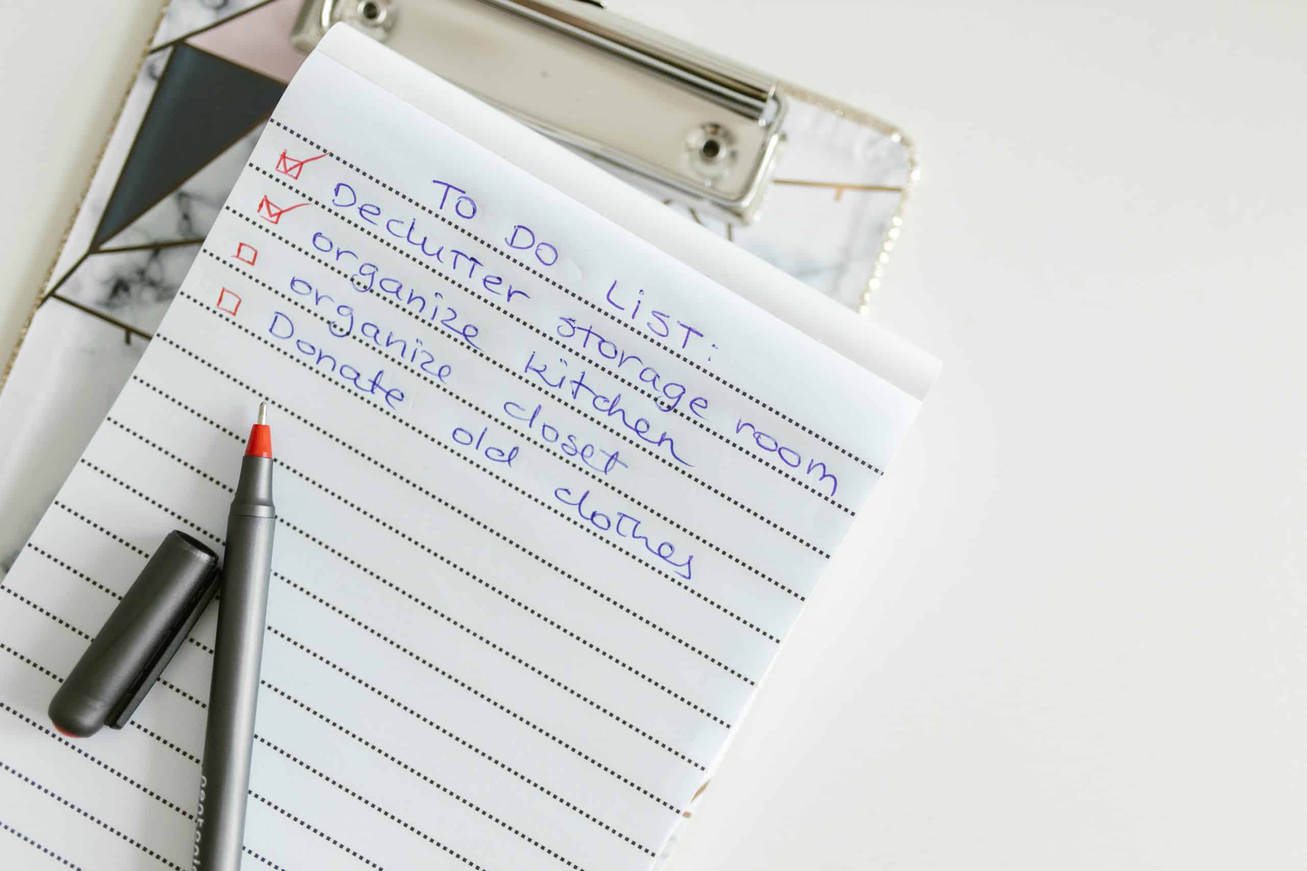 To-do list and pen. The to-do list includes point about decluttering storeroom.