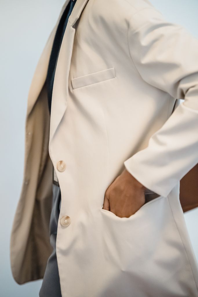 Stylish woman with hand in pocket of beige blazer for a fashion concept.