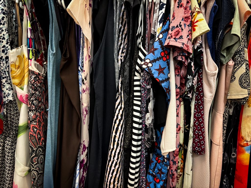 Vibrant collection of clothes hanging on a rack in different patterns and styles