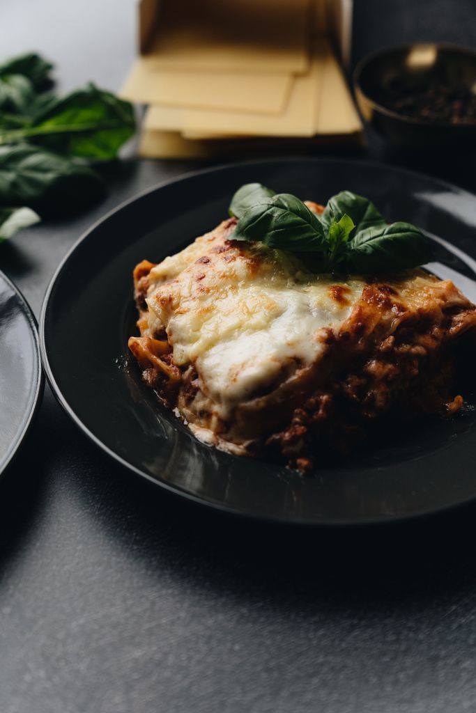 Mouth-watering lasagna topped with fresh basil made ahead of time, as as part of a simple dinner party menu